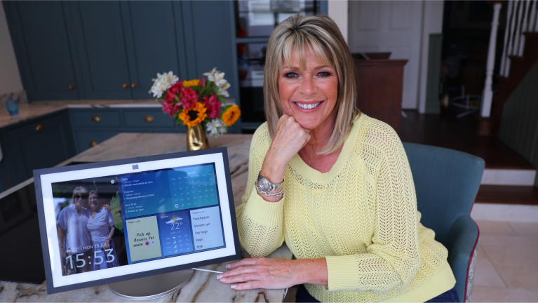 Ruth Langsford sat at a kitchen worktop with an Alexa device next to her