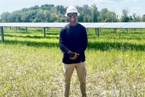 Image of Zegale Talmadge standing in a solar field in Ohio.