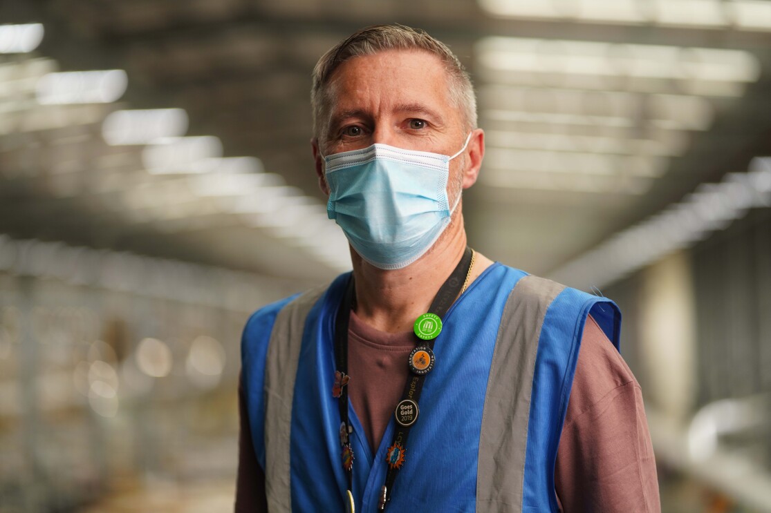 Man wearing a mask inside Amazon fulfilment centre 