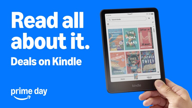 Hand holding Kindle device displaying library of book covers with text 'Read all about it. Deals on Kindle' and Prime Day logo on blue background