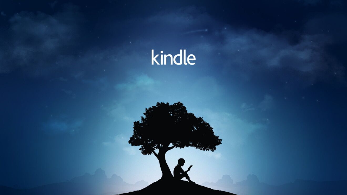 Amazon's Kindle Reader Tree brand image: a boy sits under a tree reading a book. 