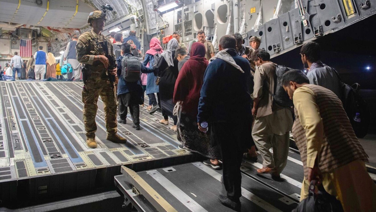 A photo of refugees boarding a military plane to evacuate Afghanistan. 