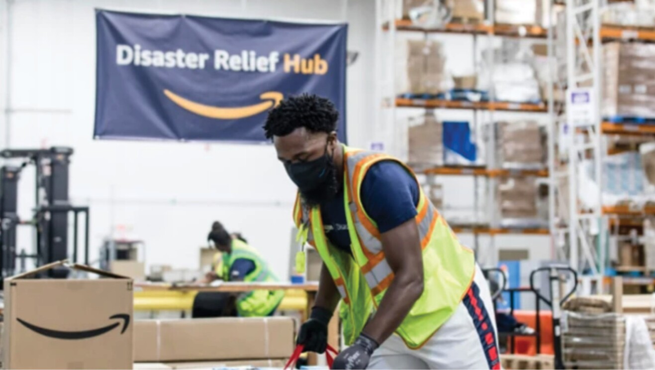 An amazon employee packs boxes of relief items to ship to Florida