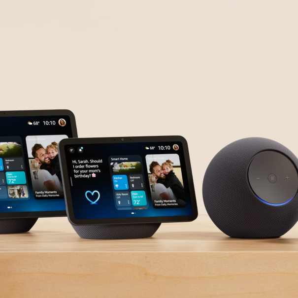 Four Amazon Echo devices of varying sizes displayed on wooden surface
