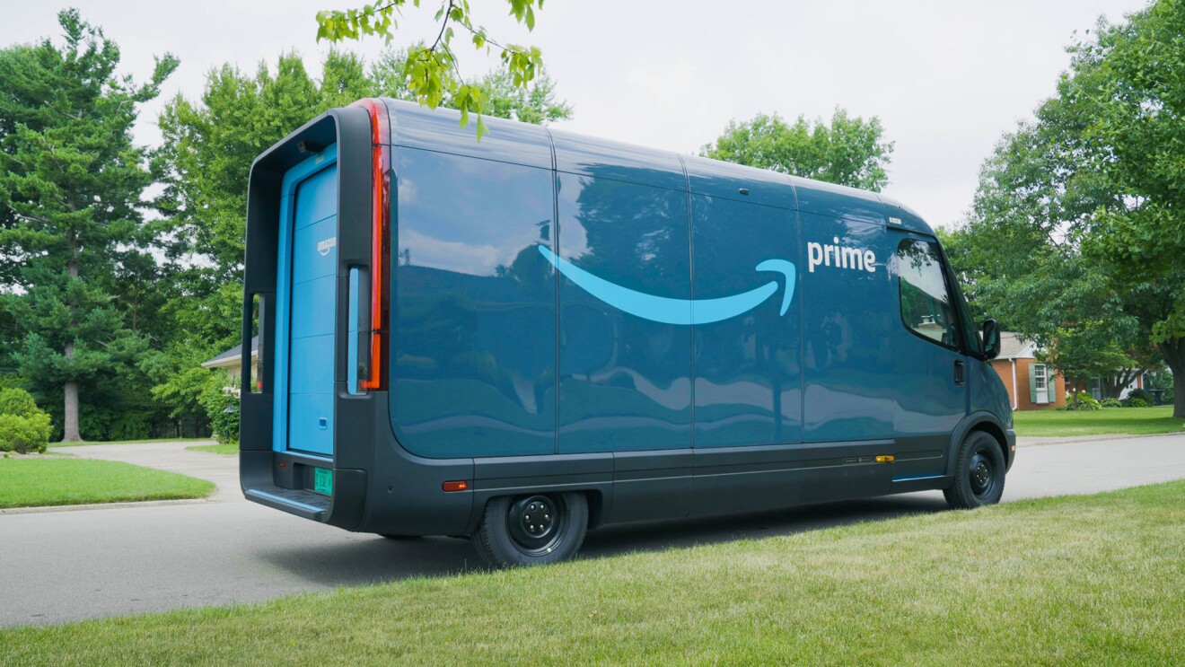 An Amazon Rivian delivery vehicle is parked outside on a residential street.