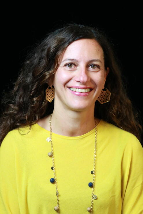 A close up head shot of Silene Bonato, Senior Programme Lead, AWS. She is smiling and looking into the camera.