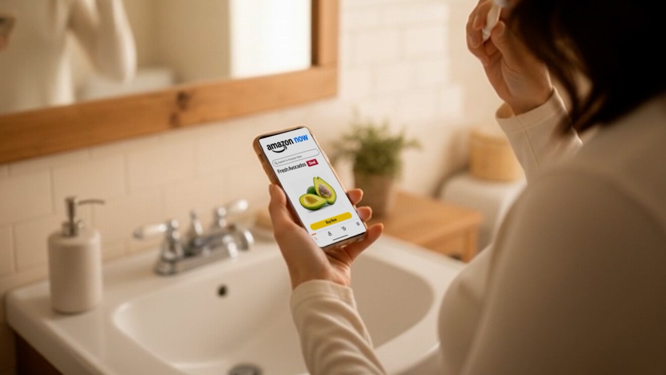 Person in her bathroom looking at Amazon Now interface on smartphone for ordering fresh produce