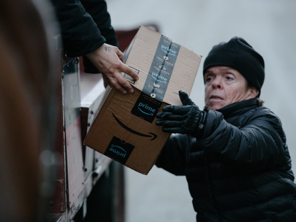 Sara helps unload Amazon packages from a delivery truck.