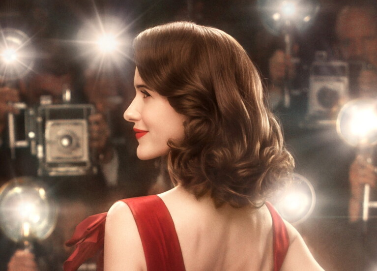 An image of Miriam (Midge) Maisel from the Marvelous Mrs. Maisel. She is on the red carpet with a lot of photographers taking pictures of her.