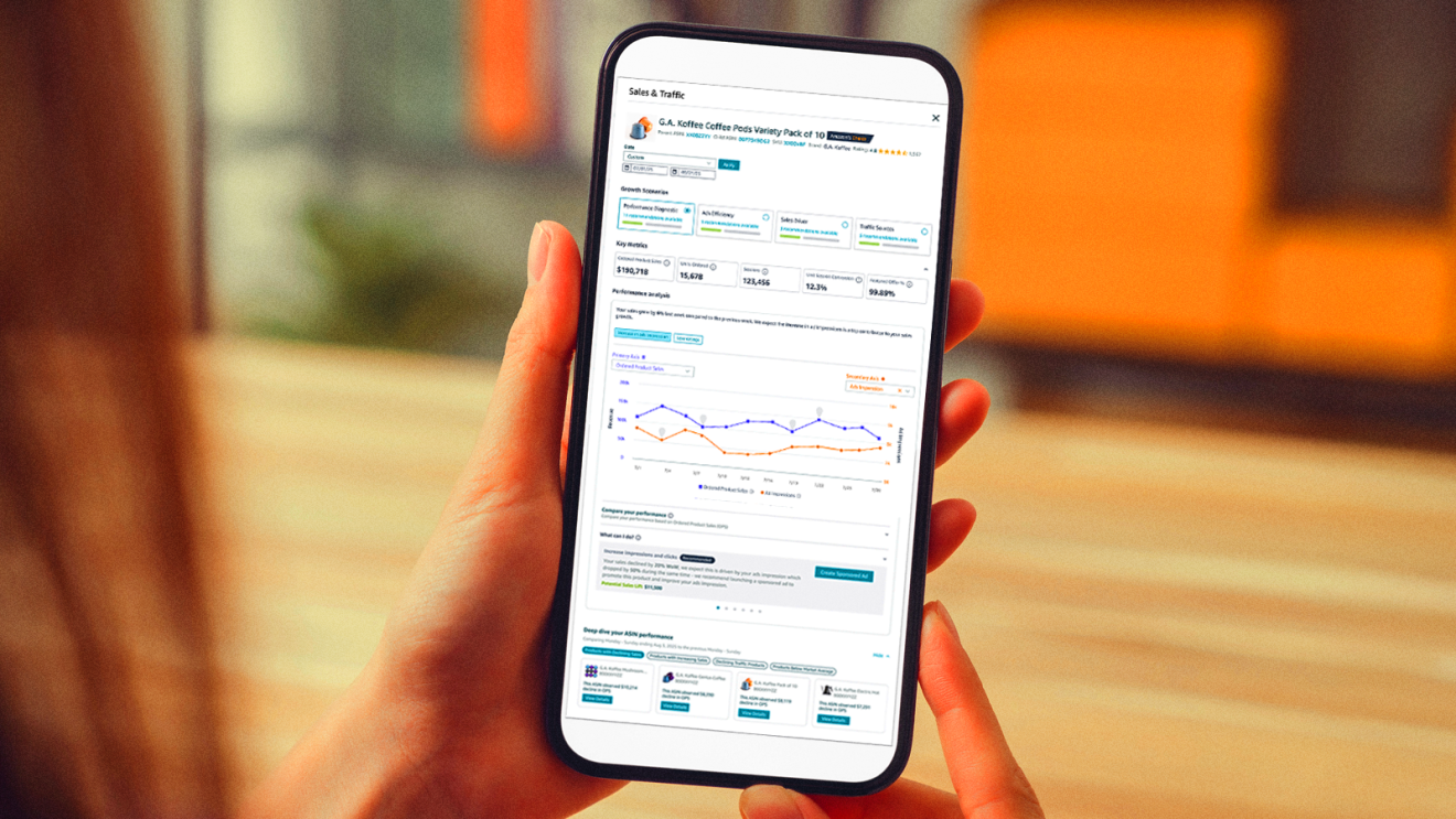 Hand holding smartphone displaying sales and traffic analytics dashboard