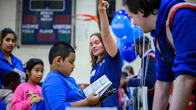 Amazon employees interact with children at a Baltimore book fair.