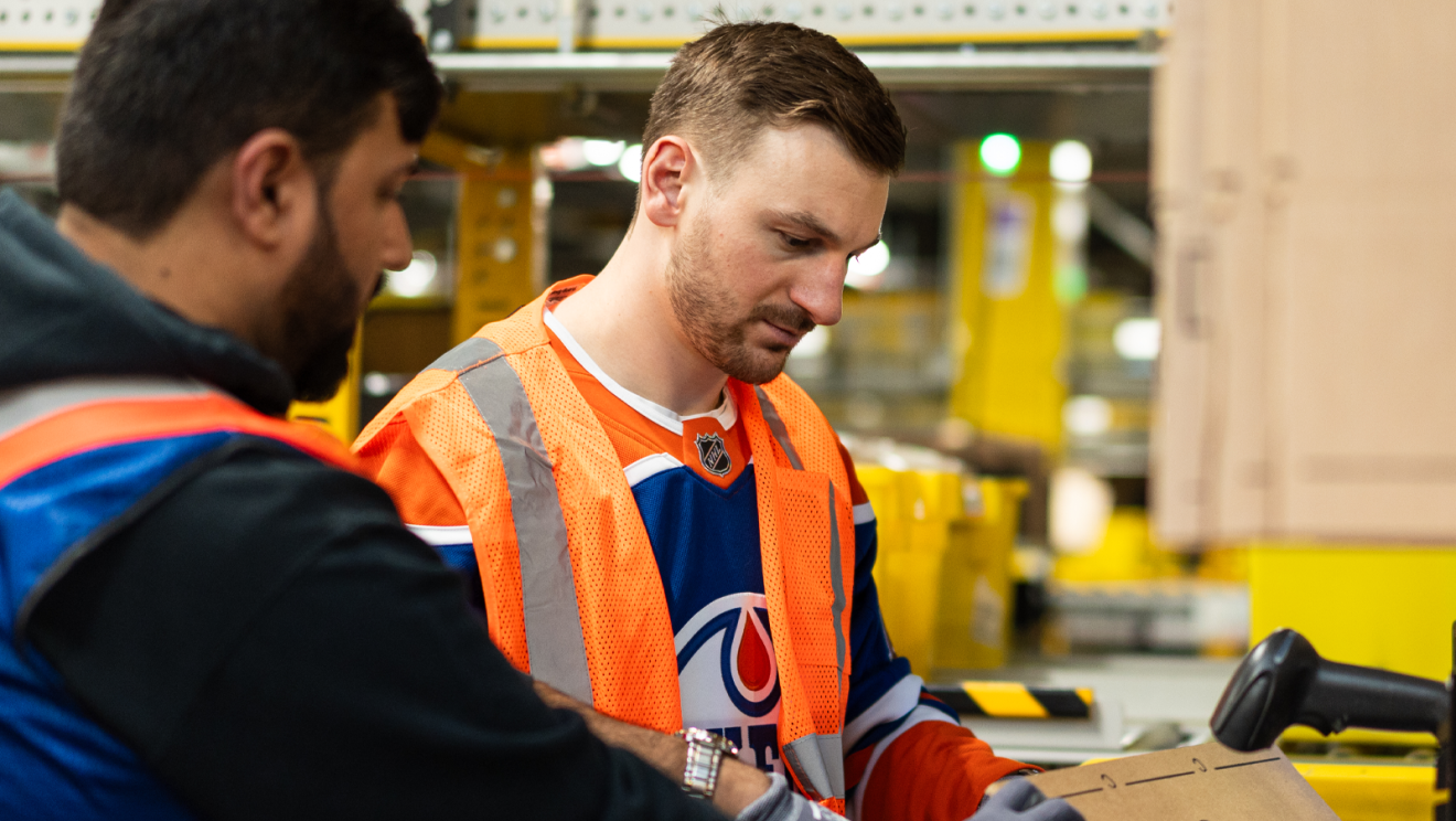 hockey player helping package boxes 