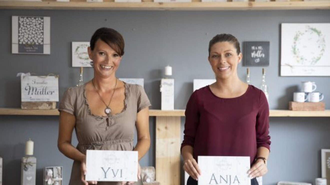 Two women bakery goods sellers named Yvi and Anja posing in their shop.  