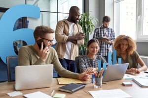 A photo of a team working in a conference room with a number six illustration in the background.