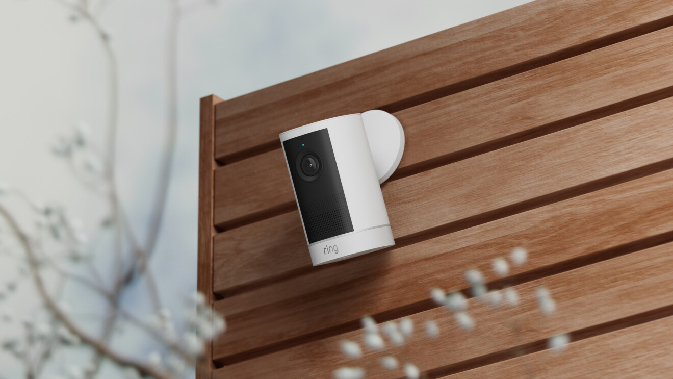 Ring security camera mounted on a wooden slatted wall outdoors