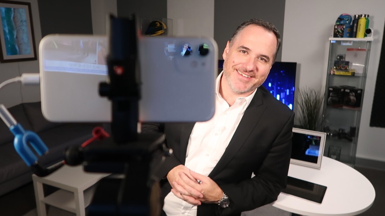 An image of Australian technology commentator Trevor Long being filmed on phone.