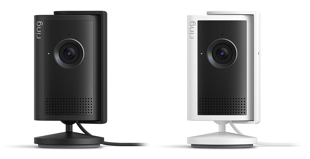 白背景に並んだ2台の監視カメラ。本体カラーは左が黒、右が白で、共に前面の黒いパネルにカメラレンズを搭載。背面から同色のコードが伸び、基部が円形のスタンドで自立している。