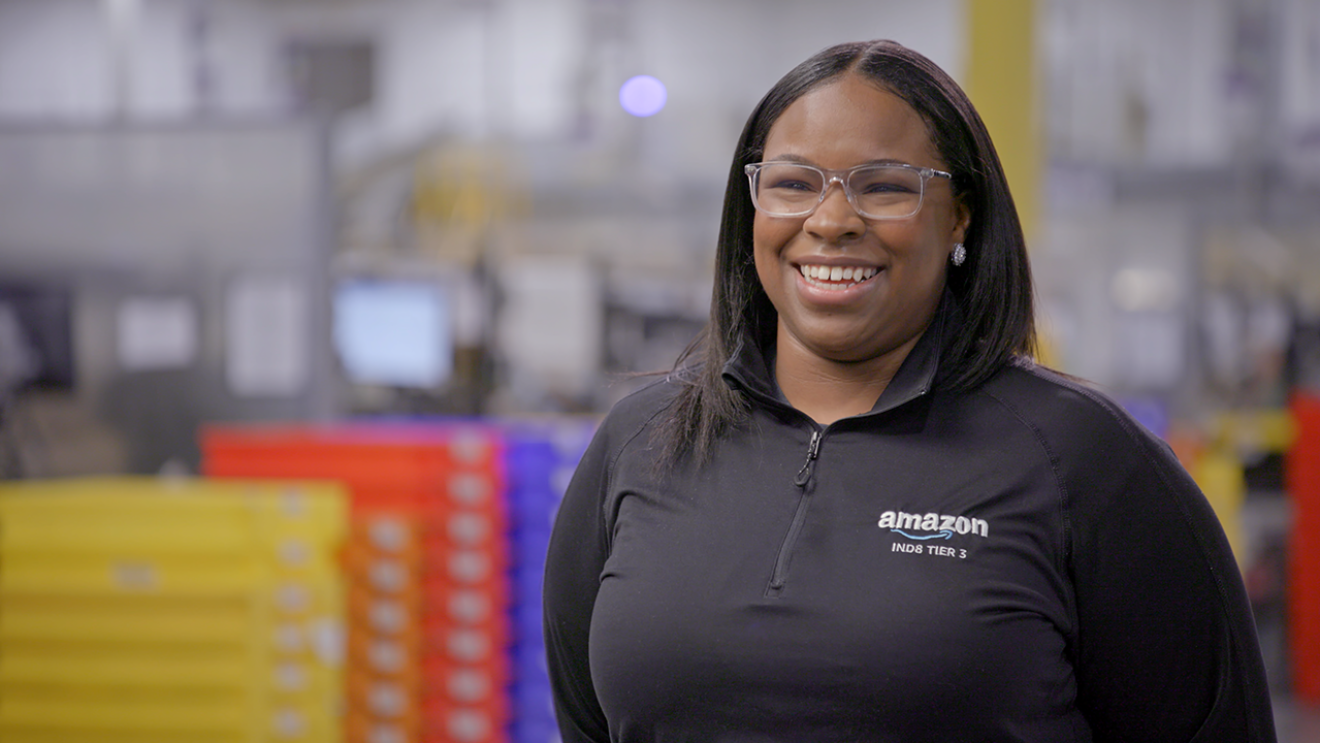 Yamana smiling while working at an Amazon fulfillment center.