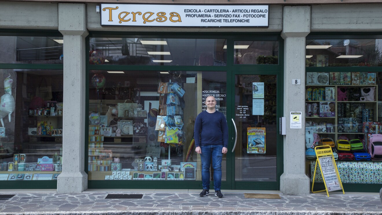 Andrea Locatelli, standing in front of the local shop "Teresa"