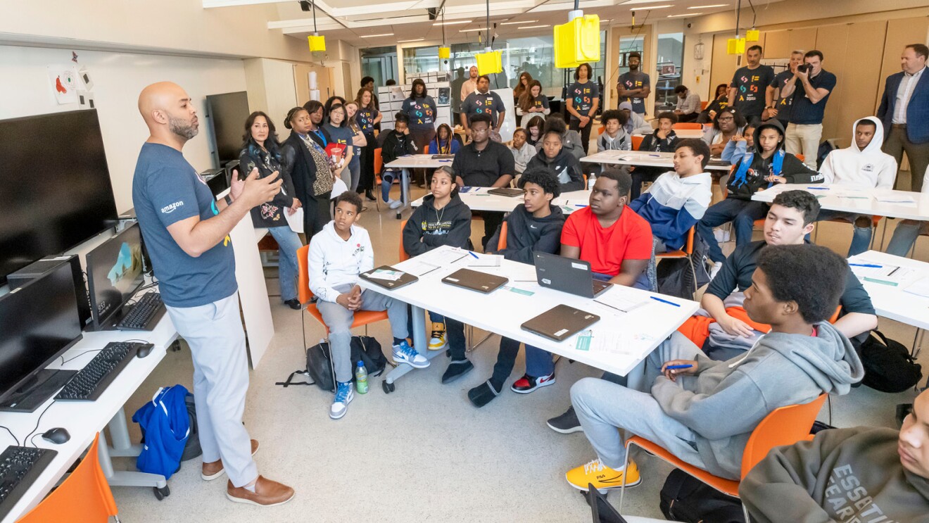 amazon employee stands in front of a classroom of students to explain careers in tech as part of the amazon future engineer program.jpg