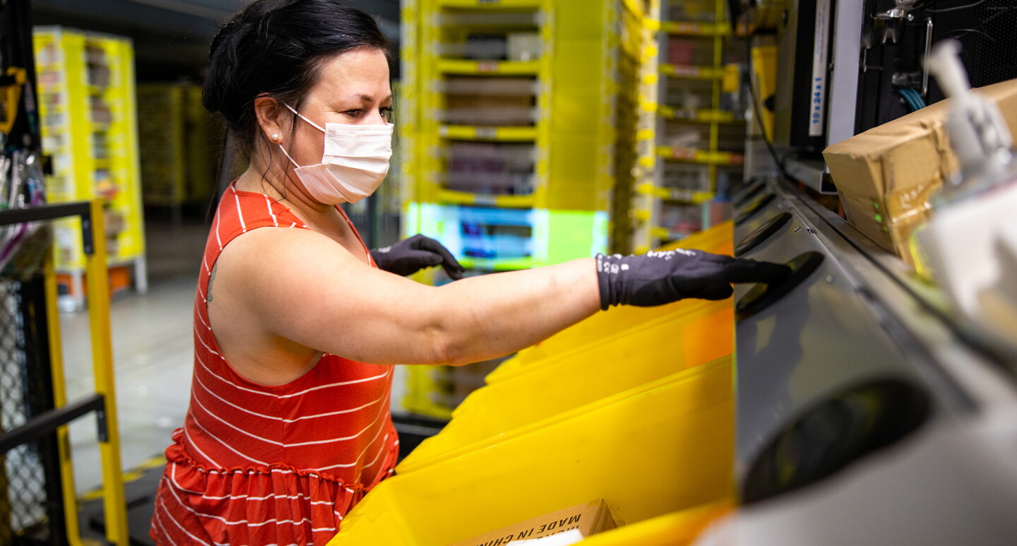 Amazon associate wears a mask while working. Photo taken during the COVID-19 pandemic.