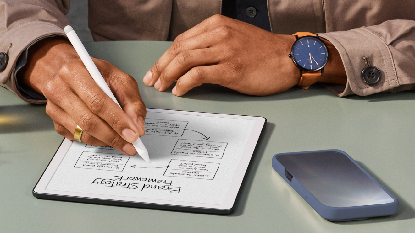 A man writing on a Kindle device using a digital pen