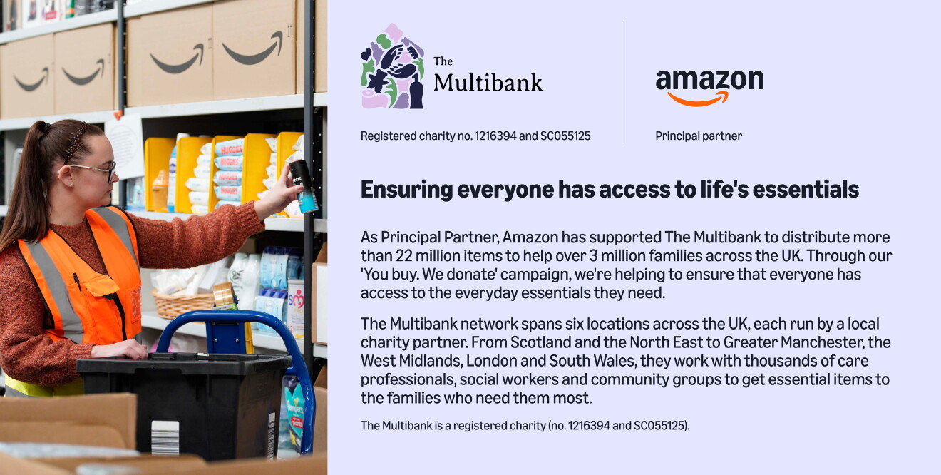 Warehouse worker in orange vest sorting donated supplies on shelves for The Multibank charity
