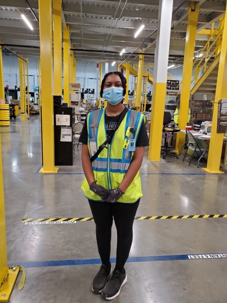 Amazon employees who work on the middle mile, posing for the camera at work