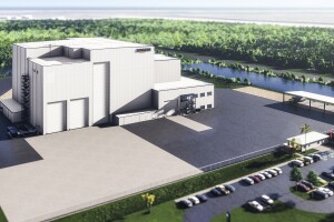 A mock-up of Project Kuiper's satellite-processing facility at Kennedy Space Center, which includes a building with the Amazon logo and a parking lot with trees around the facility. 