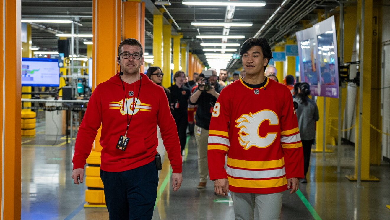 Two Calgary Flames hockey players packing and shipping Amazon boxes