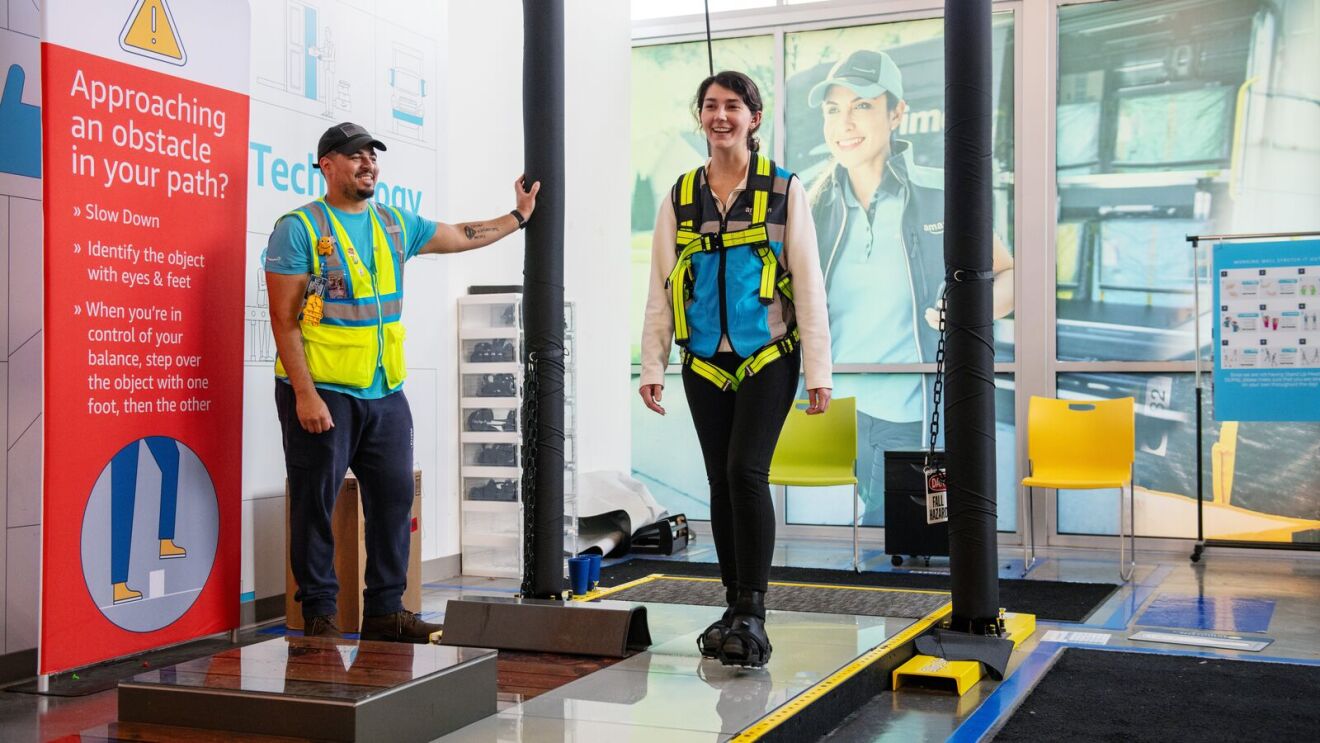 Delivery driver trainee going through the slip, trip, and fall simulator.