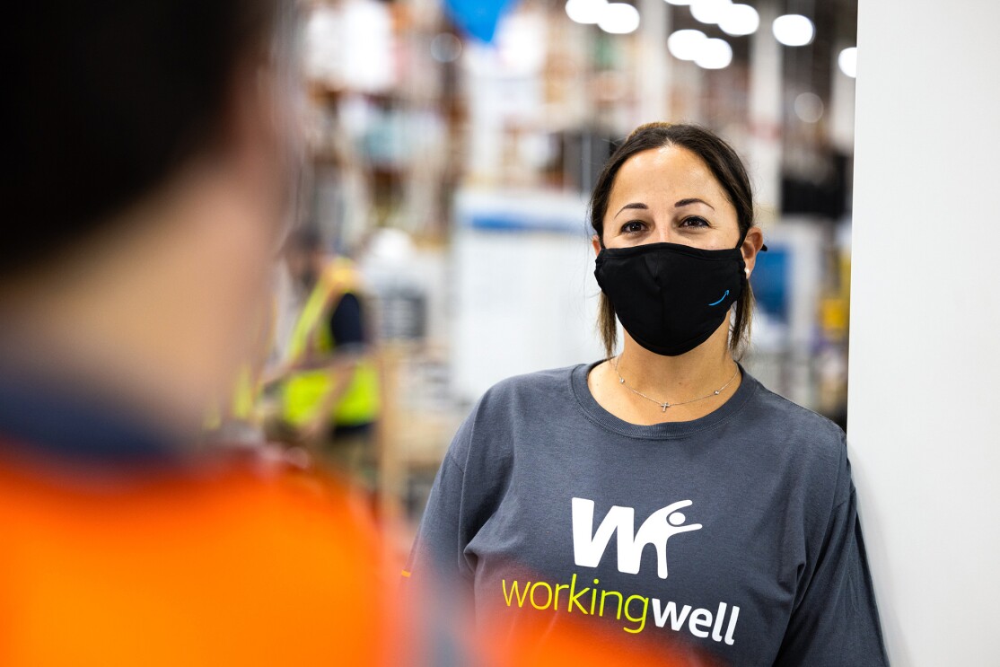 An image of an Amazon employee in a fulfillment center demonstrating how WorkingWell works.