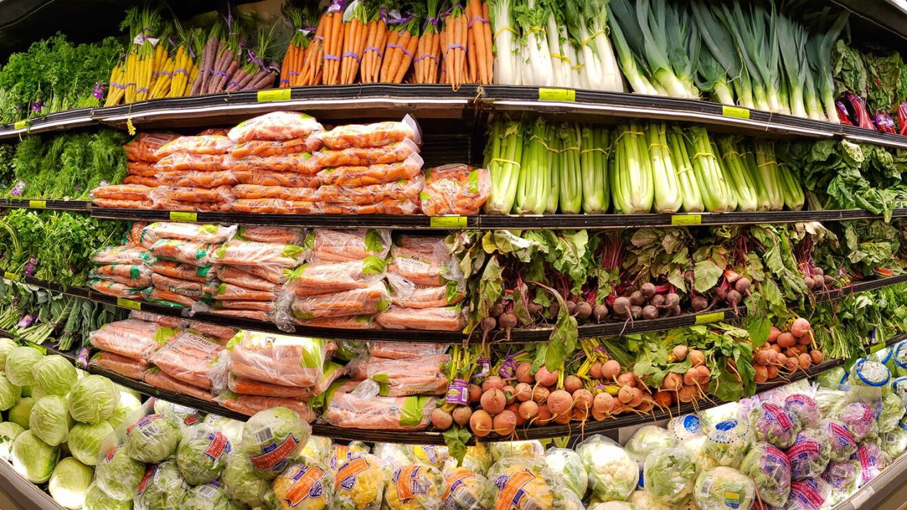 A panoramic image of a produce section in a Whole Foods Market store. 