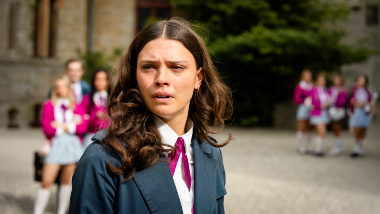 Harriet Herbig-Matten as Ruby Bell crying in the school yard with other Maxton Hall students in the background.