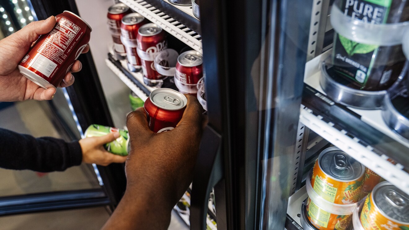 Just Walk Out Technology: hands  take products from a shelf in Amazon's Just Walk Out lab