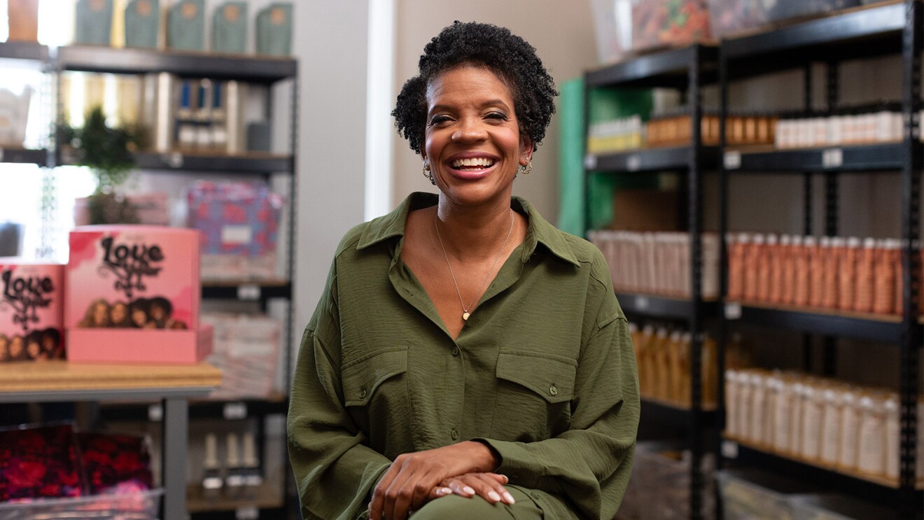 Radiant businesswoman in casual attire inside small shop