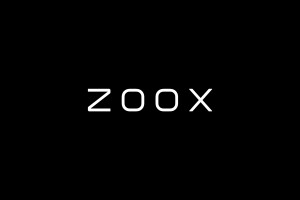 Zoox and Amazon logos in white on blue background.