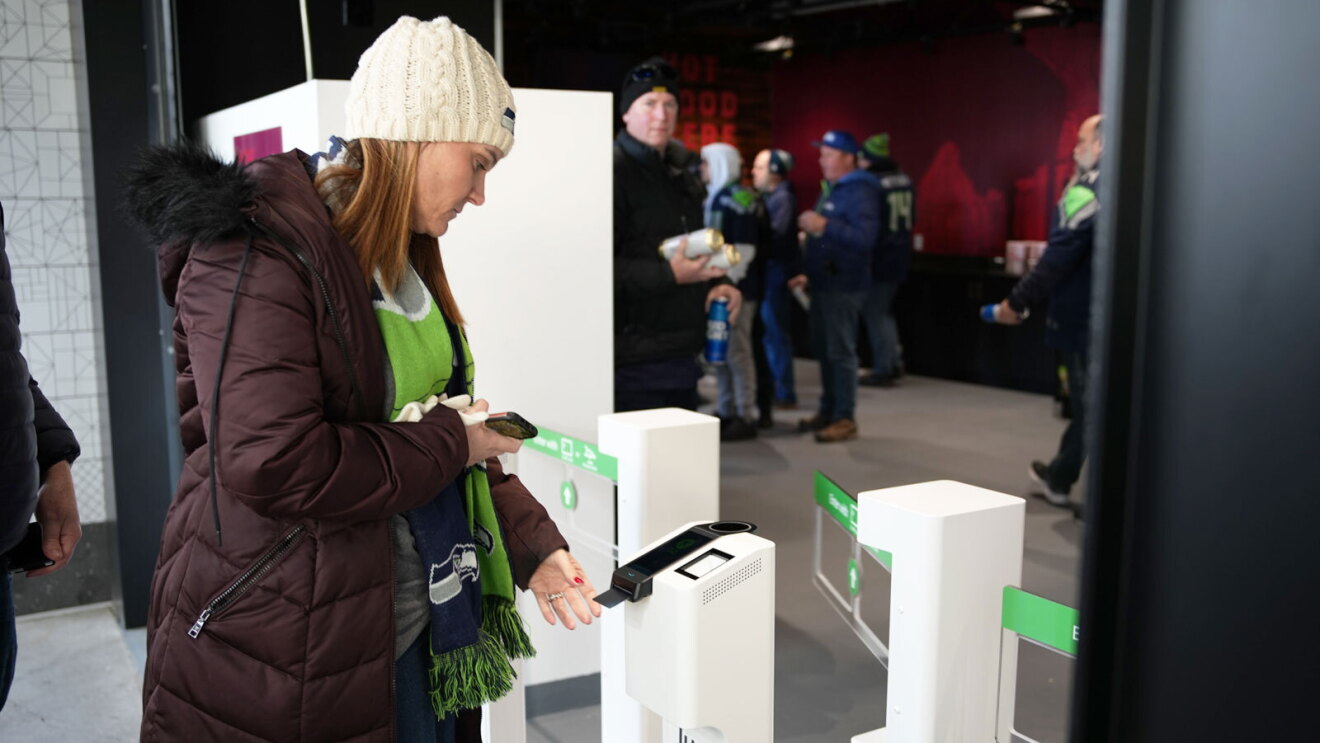 A customer inserts their credit card to enter District Market, a Just Walk Out technology store, in Lumen Field.