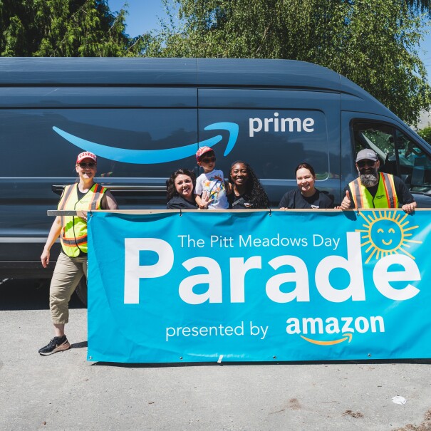 amazon employees standing in front of a truck
