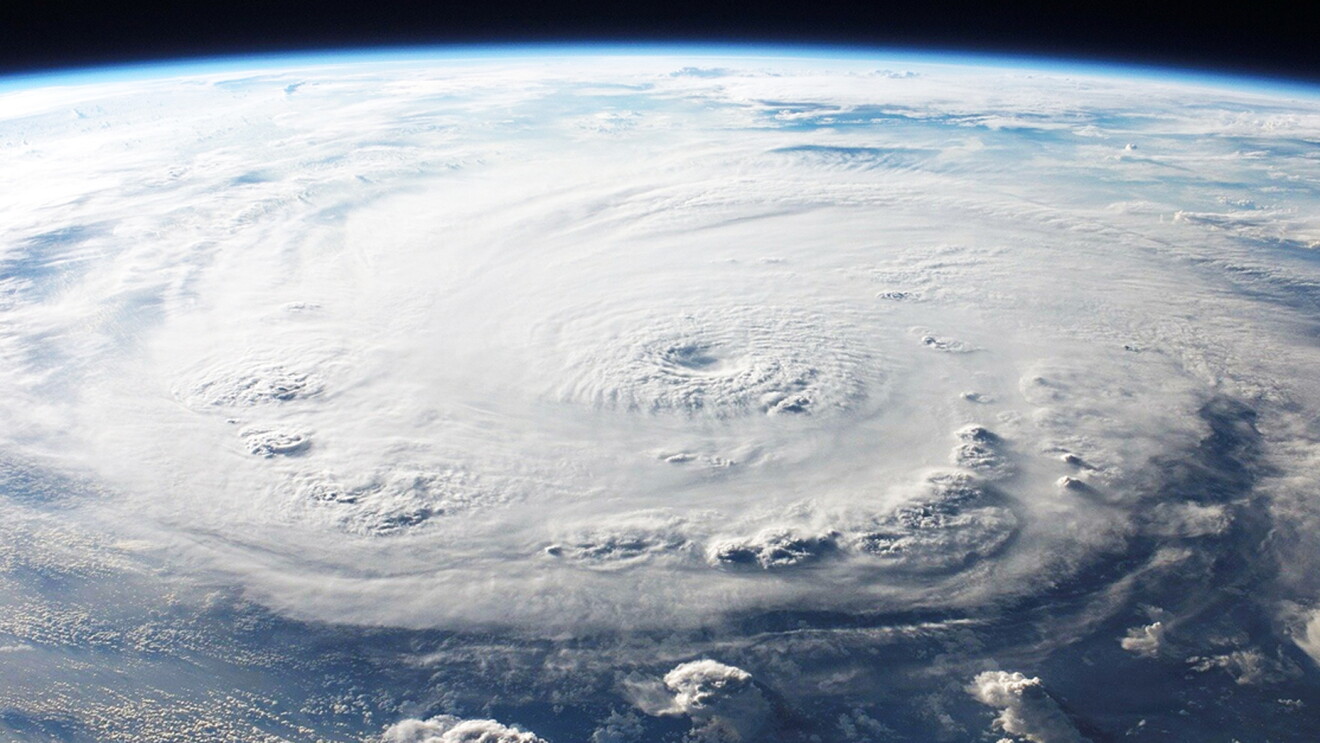 Aerial view of a hurricane swirling over the ocean.