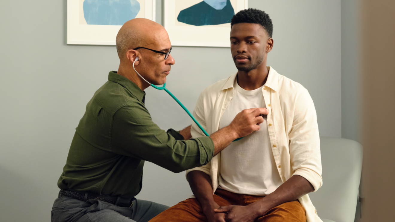 Doctor examining patient using stethoscope
