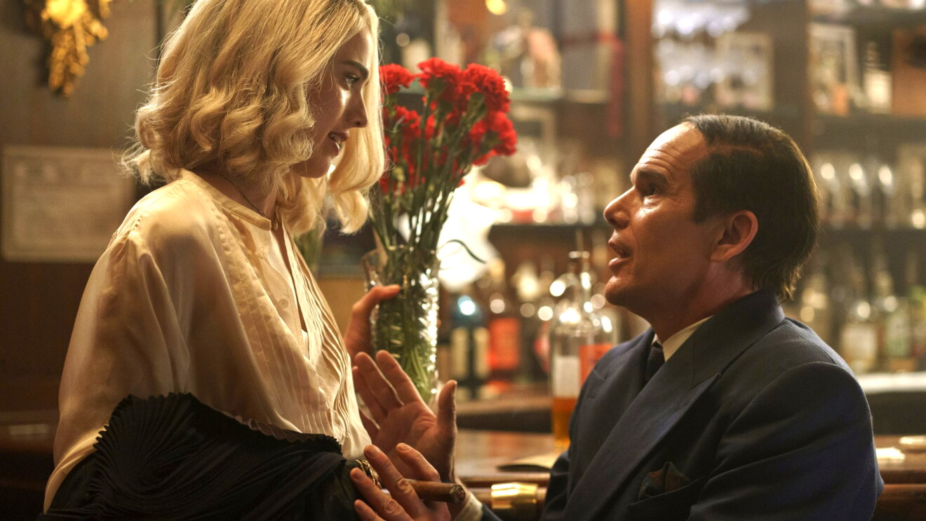 A woman and a man look at each other