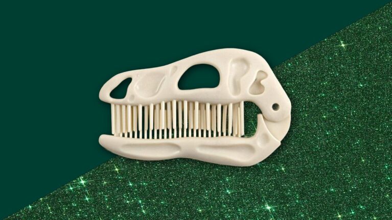 Dinosaur skull comb on sparkling green background