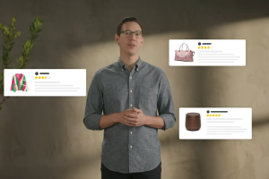 A man wearing a collared grey button up shirt stands up with three pop outs of Amazon products around him.