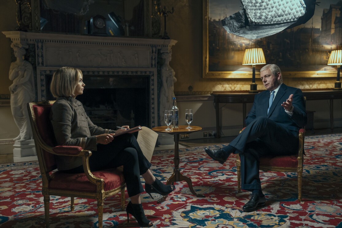 Michael Sheen as Prince Andrew sits in front of Ruth Wilson as Emily Maitlis in a recreation of the famous Newsnight interview for A Very Royal Scandal