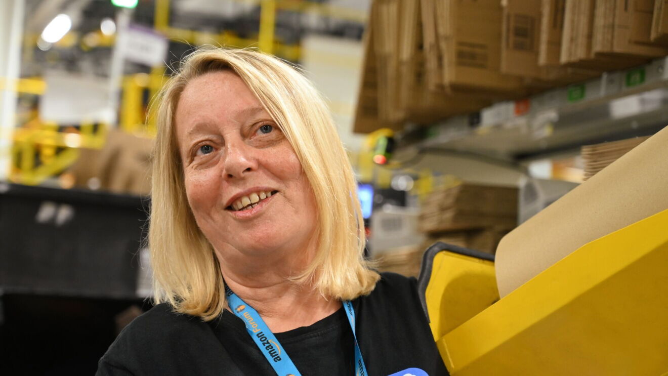 Amazon employee at packing station.