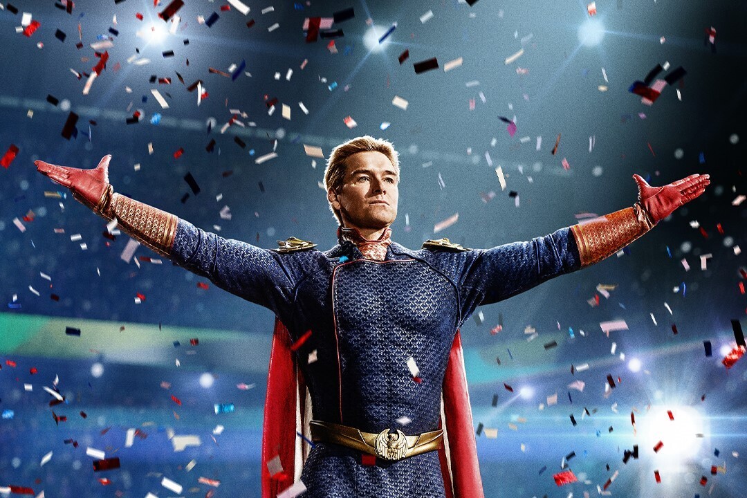 A man in a superhero costume stands among confetti