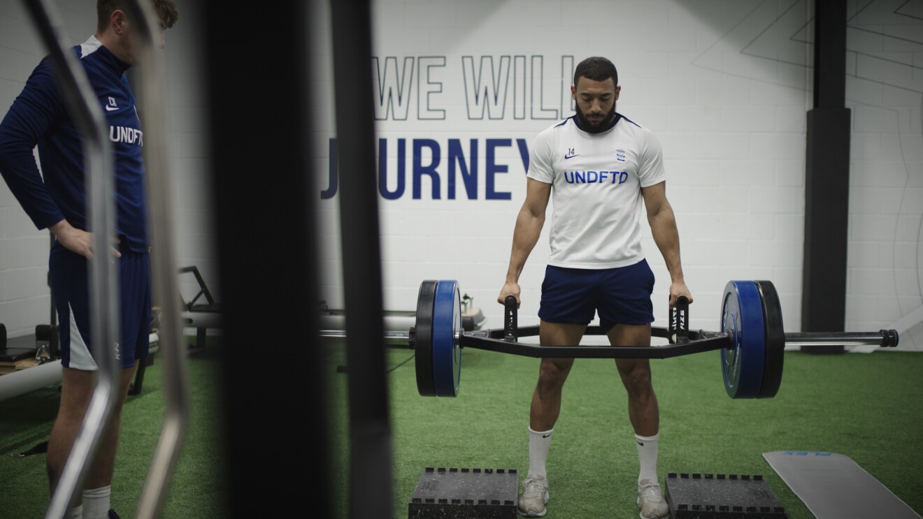 Birmingham City team member exercising in blue and white uniform