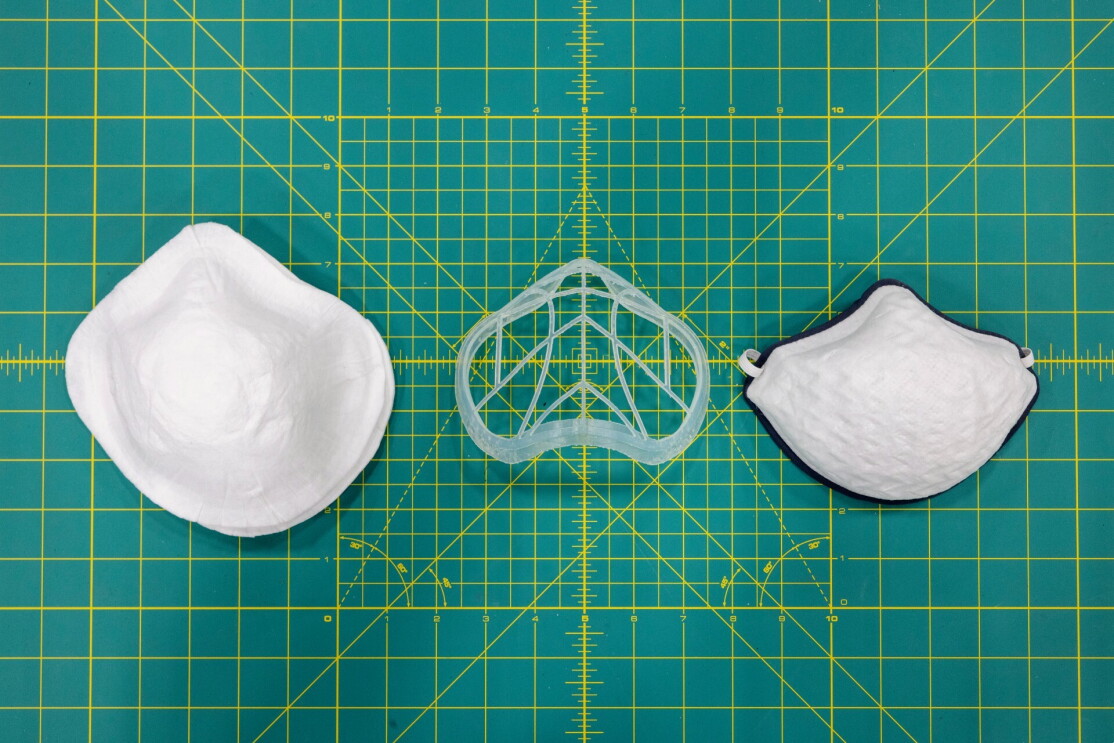 A prototype of a mask in three pieces on top of graphing paper.