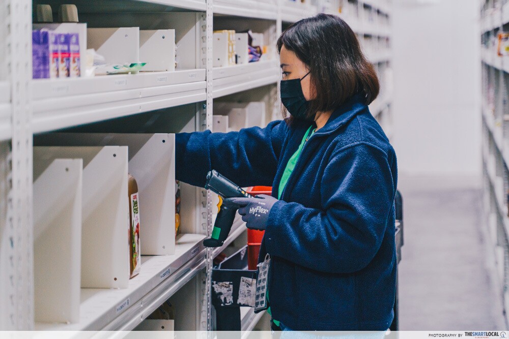 An employee scanning product codes within the chiller in the Amazon Fresh fulfillment centre